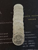 Front side lined up showing the Voyageur design and date on the bottom coin (1968 coin featured), showcasing the condition and details on these Canadian silver dollars.