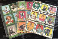 Front view of assortment of 27 NHL collectible hockey trading cards from 1971-4 O-Pee-Chee series showing various players and team logos, colorful borders.