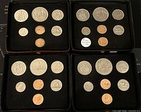 Four black display cases each holding a set of 7 Canadian coins in uncirculated condition from 1975, 1977, 1978, and 1980.