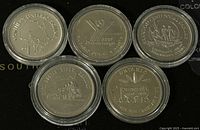 Five Canadian trade dollars in protective cases, showing provincial and centennial designs from 1979 to 1982.