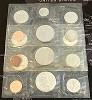 Photo of three sealed plastic packs containing multiple Canadian coins from 1980 in proof-like condition.