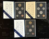 Top view of all three Canadian Specimen Coin Sets from 1988, 1989, 1990 showing coins and inserts with their denominations and face values.