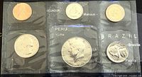 Photo showing five 1988 US coins sealed in a plastic sleeve, identified as proof-like condition coins: penny, nickel, dime, quarter, and half dollar.