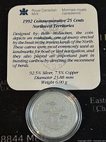 Information card showing composition and details of the coin, including 92.5% silver, 7.5% copper, 23.88 mm diameter and 6 grams weight along with historical info about the inuksuk design.