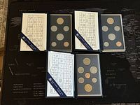Three Canadian specimen coin sets from 1994, 1996, and 1997, each in black holders with info cards visible.