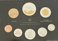 Top view of coin set featuring multiple Canadian proof coins including 2 oz silver/gold plated commemorative coin with naval design.