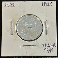 Photo shows the reverse side of a 2022 Canadian 25 cents silver proof coin in a protective holder, featuring a caribou and inscriptions marking purity and year.