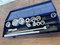 Open Kobalt metal case containing sockets, breaker bar, and ratchet wrench. Some sockets still factory wrapped.