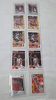 Full view of all 10 Michael Jordan basketball cards arranged in two columns, all in protective sleeves laid on white background.