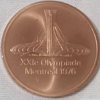 Obverse side of the 1976 Montreal Olympic participation medal showing the Montreal Olympic Stadium with inscription.