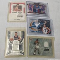 Five sports trading cards arranged on a flat surface including Jalen Johnson rookie ticket card, a FC Barcelona patch card featuring Pedri and Gavi, and three basketball jersey patch cards of Quincy Lewis, Isaac Austin, Raul Lopez.