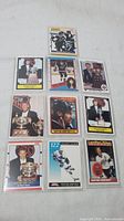 Photo of 10 Wayne Gretzky hockey cards laid out in two rows on white surface, cards in protective sleeves.