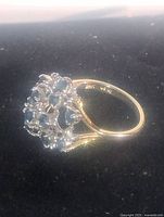 Side view of cluster sapphire ring on black background