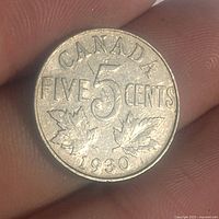 Reverse side showing denomination and date with maple leaves