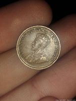 Obverse side of the 1936 Canada one cent coin showing the portrait of King George V and surrounding inscription.