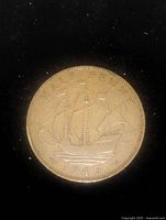Photo of the coin showing the ship design and year 1945 on the reverse side