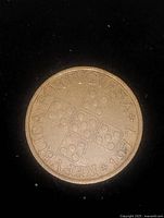 Obverse side of the 1977 Portuguese 50 Centavos coin showing five domino pieces and inscription.