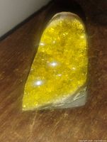 Close-up of vivid yellow citrine crystals inside the geode cluster showing the sparkling crystal points and polished surface.
