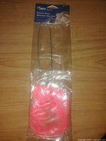 Photo of a single new packaged heavy duty minnow dip net with metal handle and bright pink netting, label visible.