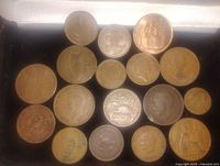All 19 coins laid out on a flat surface, showing various copper and silver tones and different designs
