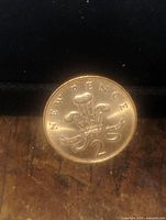 Close-up image of the front side of the 2 New Pence coin showing the crowned plume and NEW PENCE inscription
