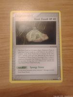 Front view of Root Fossil Trainer card with text and image visible.