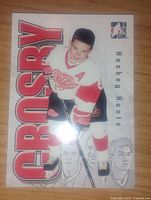 Front side of Sidney Crosby collectible card showing him in Detroit Red Wings jersey with "Crosby" in large red text.