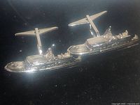 Close-up image of the pair of sterling silver yacht-shaped cufflinks, showing the detailed yacht design and polished silver finish.