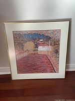 Front view of the framed artwork print showing the impressionistic colorful outdoor scene with trees and a red paved area.