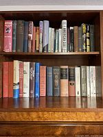 Full view of two shelves of books showing title variety and condition.