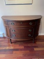 Front view of cabinet showing shape, finish and hardware