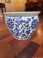 Side view of the blue and white flower pot showing floral patterns and shape.
