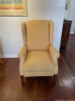 Front view of the yellow recliner chair showing fabric texture and chair shape