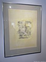 Framed abstract painting showing the entire artwork, under glass with some reflection, silver frame and visible matting.