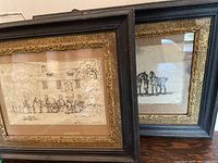Front view of two framed sketches side by side showing frames and artwork