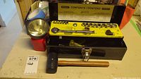 Stanley socket set in metal case, black rubber mallet with wooden handle, and large red flashlight on table