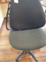 Photo of the office chair showing the fabric seat and mesh backrest with visible pet hair and some wear.
