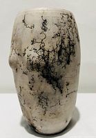 Front view of the off-white raku pottery vase showing detailed black horsehair burn imprints with organic crackle texture on surface.