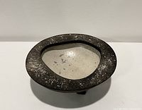 Top angled view showing the speckled dark outer rim and light crackled interior of the Raku vessel.