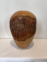 Front view of wood vase showing burl wood section.