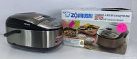 Zojirushi Micom Rice Cooker NS-TSC10 next to its original box showing front and side profiles