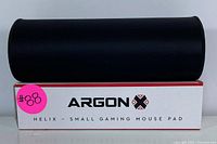 Rolled gaming mouse pad atop its box labeled 'Argon X Helix - Small Gaming Mouse Pad' with a pink sticker #88.