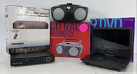 Photo showing all three items in the entertainment bundle: boxed Proscan TV converter box, boxed CD radio boombox, and portable DVD player with screen open.