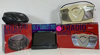 Photo of two CD radio boomboxes with their original boxes and a 10.1 inch tablet/DVD player.