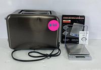 Side view of stainless steel toaster and digital food scale with manual side by side.
