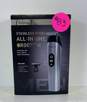 Box front showing product branding and model as Brightup Stainless Steel All-in-One Groomer for face, hair, and body grooming