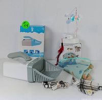 Photo showing the full set of pet accessories including the beta butterfly cat toy, blue litter scoop with box, two pet bandanas, and two pet collars.