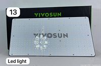 Front of VIVOSUN VS2000 LED grow light panel showing LED arrangement and brand name with packaging box behind.