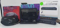 Photo displaying a black CD radio boombox alongside a Proscan DVD player and a portable Proscan 10 DVD player, each with their respective boxes.