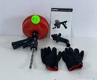 Full lot overview: red DuroFort handheld drain auger with black handle, drill attachment, black gloves with red trim, and user manual shown on a white background.